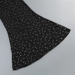 Detailed macro view of black mesh fabric with sparkling silver sequins and flared cuff design
