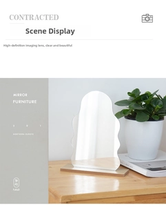 Close-up of irregular wavy acrylic mirror with minimalist wooden base on a desk