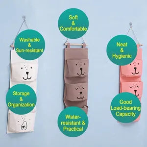 Wall-mounted fabric storage bags in beige, coffee, and pink with cute animal designs
