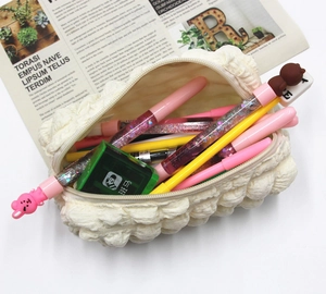 Detail of soft cream puff pencil case with bubble texture and various colorful stationery