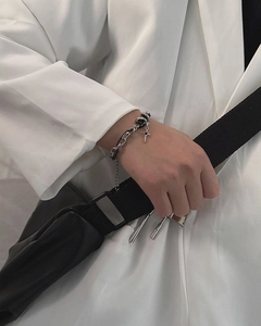 Detail of titanium steel double-layer chain bracelet with star cross pendant on wrist