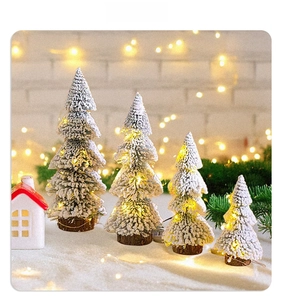 Mini cedar Christmas trees with snow effect and warm LED lights on wooden bases