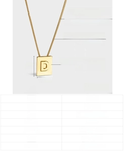 Macro detail of gold letter D pendant showing dimensions and 18K gold plated steel texture