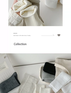 Detail of ribbed knit cotton knee-high socks in cream, grey, and black tones