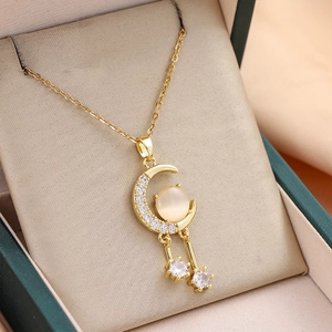 Luxurious gold star and moon planet necklace with cat eye stone on jewelry box