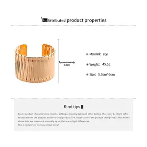 Detail view of wide golden irregular geometric open cuff bracelet with product dimensions