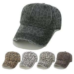Close-up of leopard print distressed baseball caps featuring vintage worn details and texture