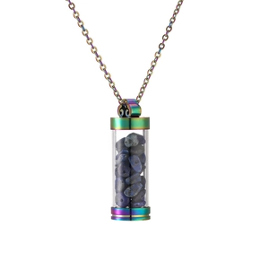 Macro detail of rainbow stainless steel perfume bottle pendant filled with blue lapis lazuli
