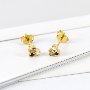 Detail of gold studs featuring three small round multi-color cubic zirconia clusters