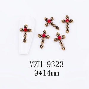 Detailed retro bronze cross nail charms with red rhinestones and floral textures