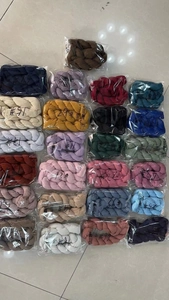 Bulk display of colorful crinkled voile table runners in various vibrant hues and packaging