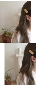 Close-up of a matte yellow oval hair clip worn by a model in a side view pose