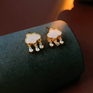 Detailed view of cloud earrings with white enamel and sparkling water-drop zircons