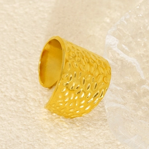 Adjustable gold titanium steel ring featuring a luxury hammered texture on a warm background