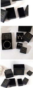 Detail of matte black jewelry gift box with gold foil stamping and matching carry bag