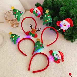 Close-up of seven glowing LED Christmas headbands with Reindeer and Santa designs