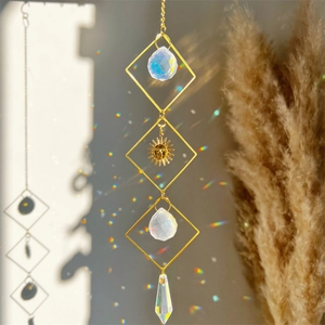 Golden moon sun catcher with clear quartz crystals casting rainbow light reflections