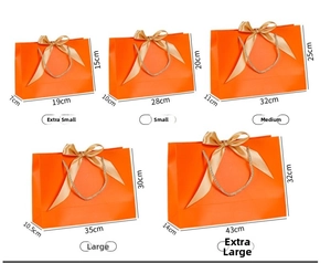 Size chart for orange gift bags with golden ribbon bow in five various dimensions