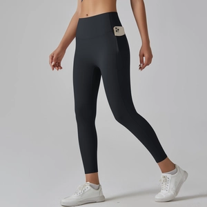 Close-up of high-waisted black yoga leggings featuring a functional side phone pocket