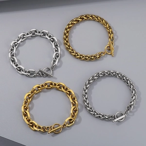 Golden and silver stainless steel hip-hop bracelets with OT buckle on gray background