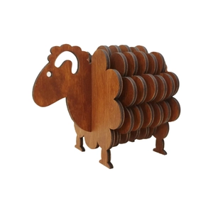 Detail view of 3D sheep-shaped wooden coaster with dark brown grain texture on white background