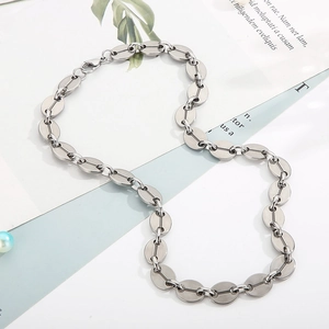 Detailed view of silver coffee bean chain necklace in polished stainless steel finish