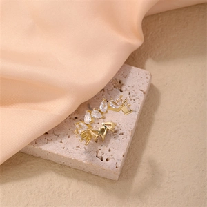 Detailed close-up of golden wavy adjustable ring with pear-cut and marquise-cut gems
