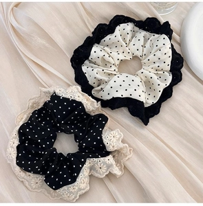 Detail of polka dot scrunchies with elegant lace trim in black and white styles