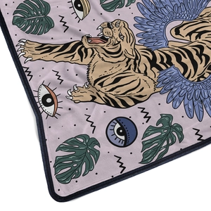 Close-up of flannel blanket with vibrant tiger illustration and refined blue hem detail