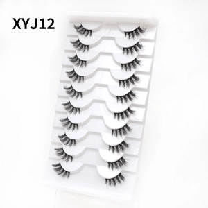 Detailed close-up of 10 pairs of cat-eye false eyelashes on a professional white tray