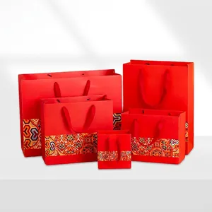 Red Chinese style paper gift bags with traditional patterns and silk ribbon handles