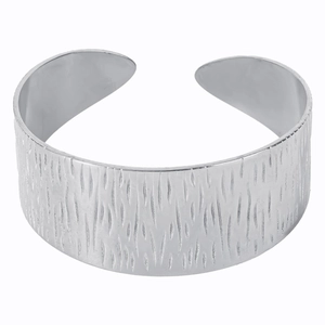 Macro detail of silver C-shape bangle showing textured bark finish and metallic luster