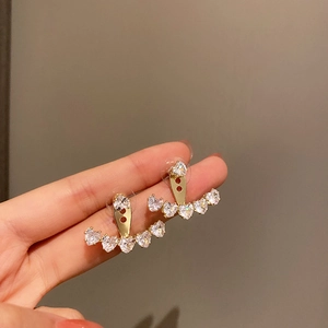 Detail of gold heart-shaped cubic zirconia earrings with a versatile two-way wearing design