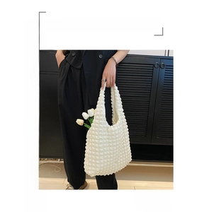 Detail of white popcorn texture fabric on a minimalist Korean tulip shoulder bag