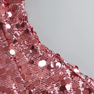 Detailed macro view of sparkling rose pink sequins on a mesh A-line party dress