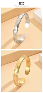 Close-up of gold and silver hammered texture open cuff bangles in a tile display
