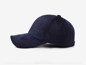 Detail view showing deep blue fabric texture and mountain embroidery on the baseball cap