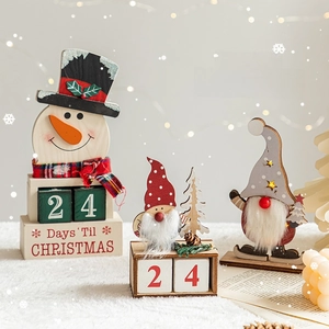 Wooden Christmas countdown calendar with snowman and gnome figurines on holiday tabletop