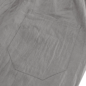 Detailed macro view of the pocket stitching and breathable gray linen fabric texture