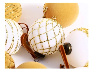 Detail of white and gold velvet Christmas balls with glitter stripes and pearl accents
