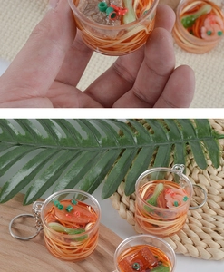 Macro view of mini beef noodle soup keychain with realistic vegetable and meat details
