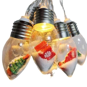 Detailed view of LED Christmas light bulbs featuring mini trees and warm yellow glow