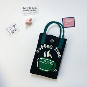 Black knitted phone bag with coffee time pattern and dark teal handles on white background