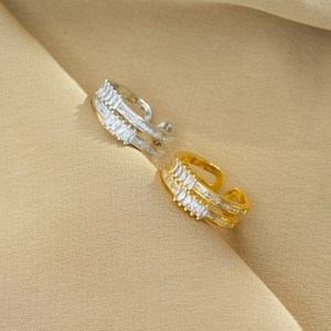 Close-up of double-layer open rings with square cubic zirconia in gold and silver