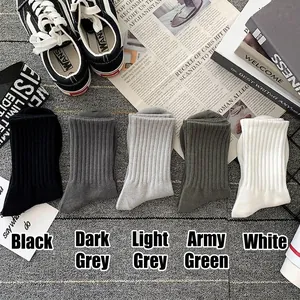Five pairs of rib-knit cotton mid-calf socks in diverse neutral colors with sneakers
