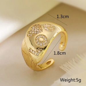 Detail view of irregular gold ring with cubic zirconia letter inlay and dimensions