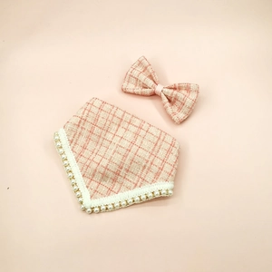 Detail of pink plaid tweed pet bandana with pearl trim and matching bow tie