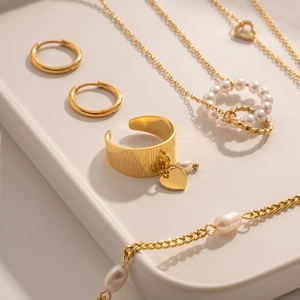 Detailed view of 18K gold plated jewelry set with star pendant ring and pearl necklaces