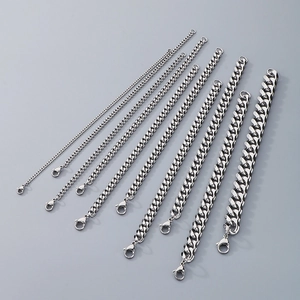 Detail of various widths of silver stainless steel Cuban link bracelets with lobster clasps
