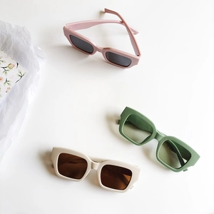 Retro rectangular sunglasses in pink, dark green, and cream white displayed on white